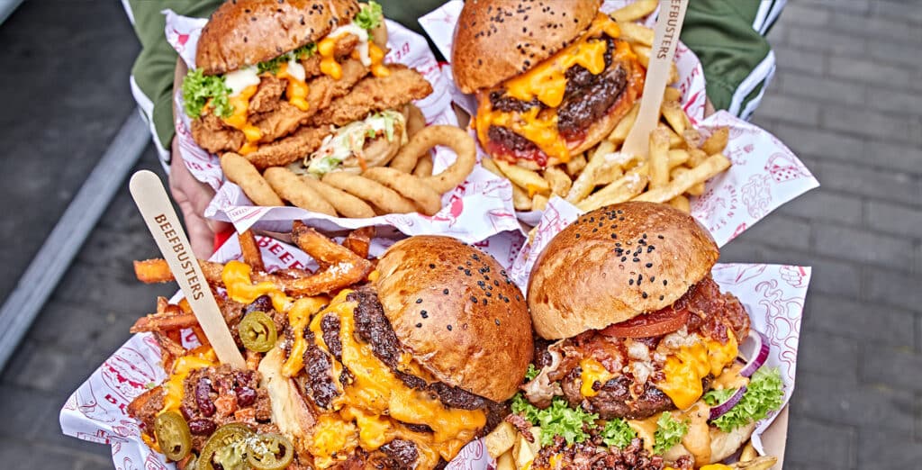 Burger und BBQ mit Fritten und vielen Extras in einer Beefbusters Verpackung